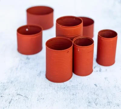 High angle view of red cans in different sizes on the table under the lights Stock Photos