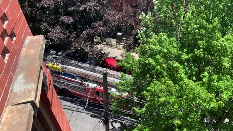 High Angle View of Red Firetruck responding to call on street corner in Jersey Stock Footage 133464762