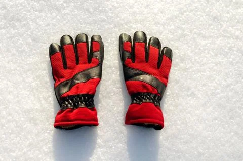 High angle view of  red  pair of winter ski gloves on snow Stock Photos