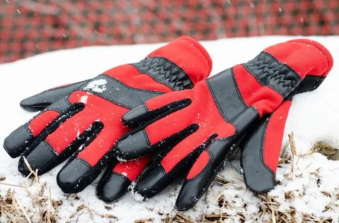 High angle view of  red  pair of winter ski gloves on snow Stock Photos