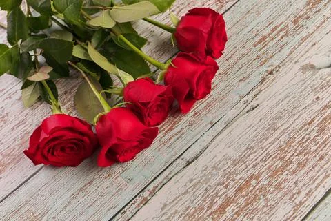 High Angle View of Red Roses on Rustic Wood Table Stock Photos