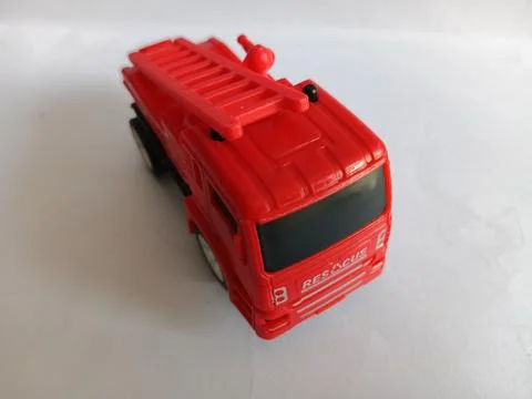 High Angle View of a Red Toy Fire Truck with Ladder on White Background 库存照片
