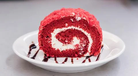 High Angle View Of Red velvet swiss roll Served In Plate On Table Stock Photos