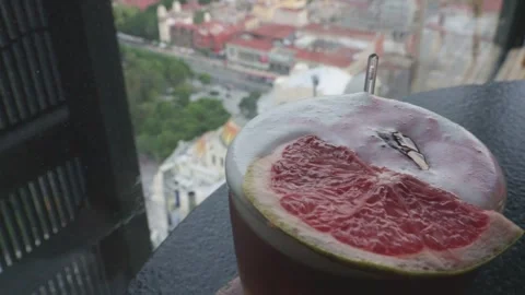 High angle view of a refreshing grapefruit cocktail with the mexico city skyline Stock-Footage 340912599