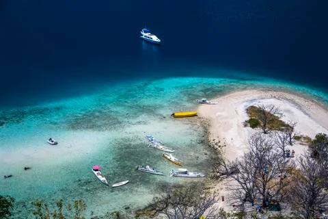 High angle view of a remote beach and boats in pacific ocean, Komodo National Stock Photos