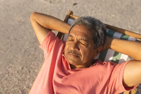 High angle view of retired senior biracial man sleeping with hands behind head Stock Photos
