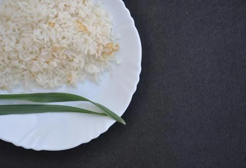 High angle view of rice in white plate isolated over black background  Stock Photos