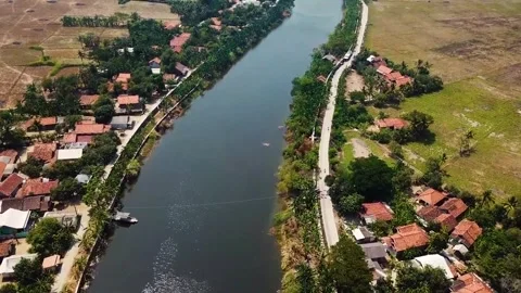 High Angle View of River Flowing Through Rural Village Stock Footage 327895022