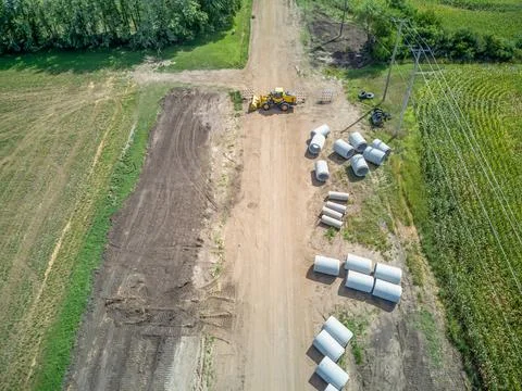 High angle view of a road construction project cutting through an agricultural Stock Photos