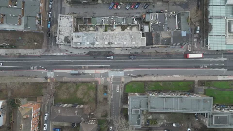 A high angle view of a road with moving vehicles in a residential area. Video stock 261929085