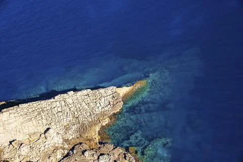 High angle view of rock formation on Mediterranean seaside during sunny day Stock Photos
