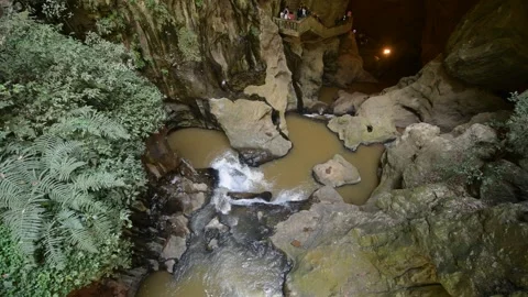 High angle view of a rocky river flowing through a deep limestone karst cave Stock Footage 342278006