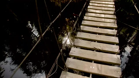 High angle view of a rope suspension bridge over a river. Stock Footage 283534772