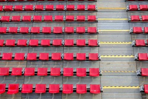 High angle view of rows of empty red plastic seats and concrete stairs with.. Stock Photos