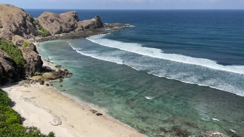 High angle view of sandy beach, ocean and rocks. Stock Footage 340457608
