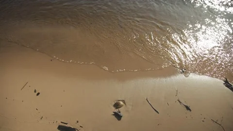 High angle view of sandy sea shore with waves hitting the sand banks Stock Footage 161153224