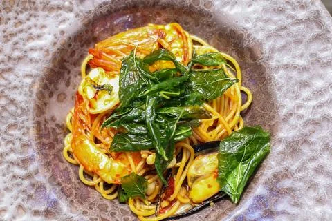 High angle view of seafood basil spaghetti with a spicy Thai flavor. Stock Photos