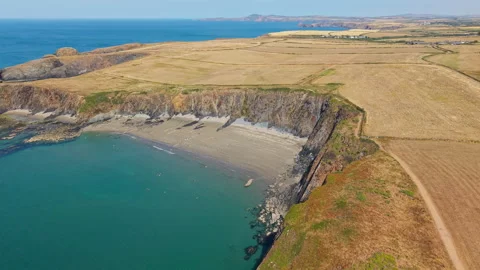High Angle View of Secluded Sandy Cove and Ocean Cliffs, Aerial Pullback Stock Footage 346097489