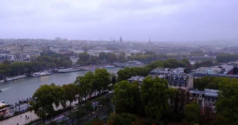 High-angle view of the Seine River and Paris cityscape under rainy overcast sky Stock Footage 328525097