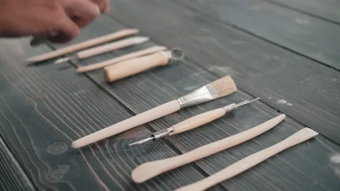 High angle view of a selection of pottery tools on a board in a workshop, potter Stock Footage 143475766