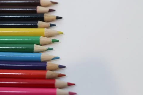 High-Angle View of Sharp Colorful Pencils in a Row on White Background with  Stock Photos