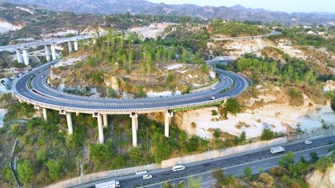 High-angle view of sharp S-curve road and structural pillars at golden hour suns Stock-Footage 335643012