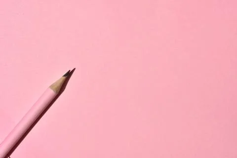 High Angle View of sharp wooden pencil on pink background. Stock Photos
