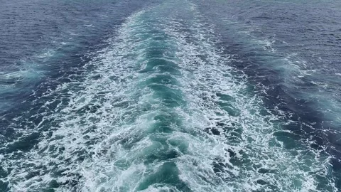 High-angle view of a ship's wake churning the deep blue ocean water Vídeos de archivo 335043359