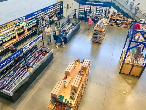 High-angle view of shoppers browsing cheese and snack displays in a modern .. Stock-Fotos