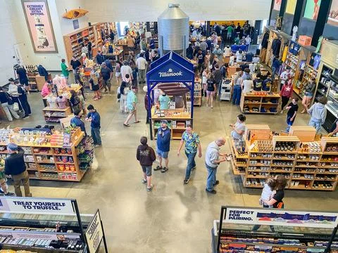 High-angle view of shoppers browsing merchandise and cheese displays inside.. Stock-Fotos