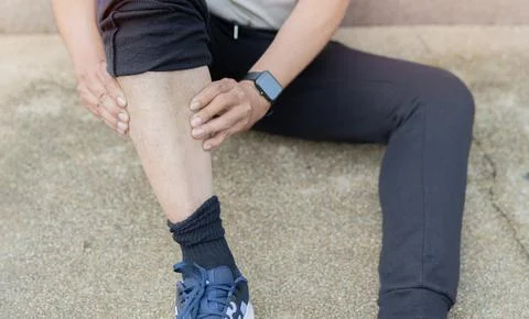 High angle view shot of man after fitness workout and jogging sits on the g.. Stock Photos