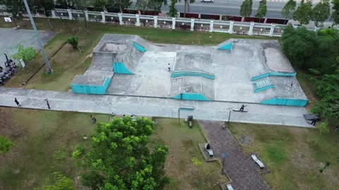 High-angle view showcasing a modern concrete skatepark facility amidst lush.. Stock Footage 339037080