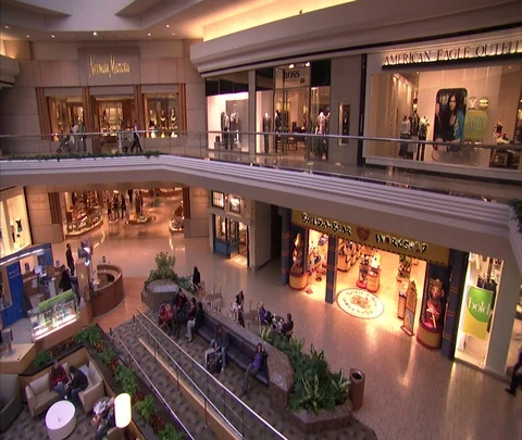 High angle view showing two levels of mall, pan left past Nieman Marcus. Stock Footage 86748477