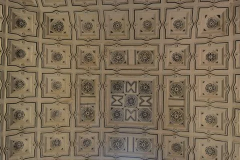 A high-angle view shows an ornate ceiling with a grid of recessed square pane Stock Photos