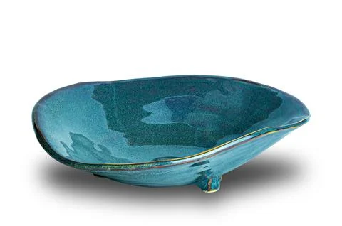 High angle view of single blue deformed ceramic plate with three legs . Stock Photos