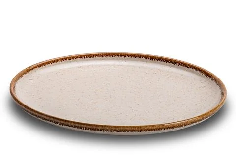 High angle view of single empty round spotted brown ceramic plate with brow.. Stock Photos