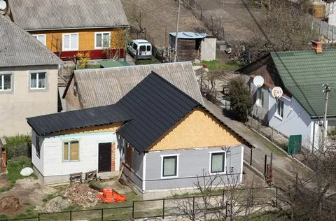 High angle view of a small house under renovation with a new black metal ti.. Stock-Fotos