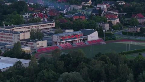 High angle view of a small town sports stadium surrounded by residential houses 스톡 동영상 347875368