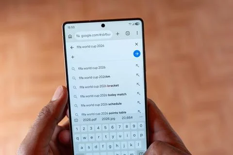 High Angle View of Smartphone Held in Hands Showing Google Search Results. Фото