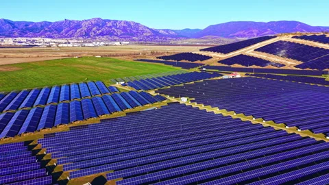 High-angle view of solar panel array rows across open field, Bulgaria Stock Footage 335689695