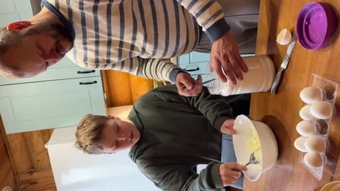 High angle view of son mixing cottage cheese in bowl while father Stock Footage 347363500
