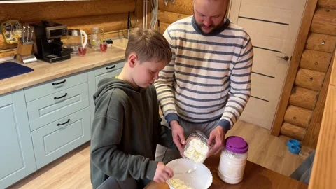 High angle view of son using spoon to put cottage cheese Vídeo Stock 347363261