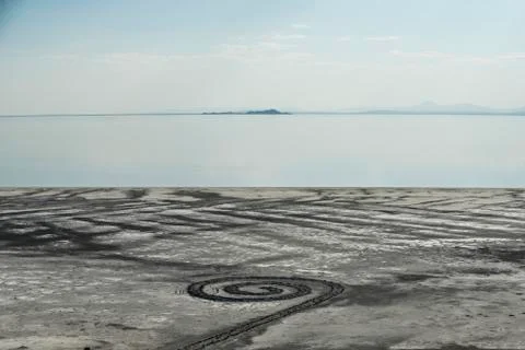 High angle view of spiral pattern on sand by Great Salt Lake against sky Stock Photos