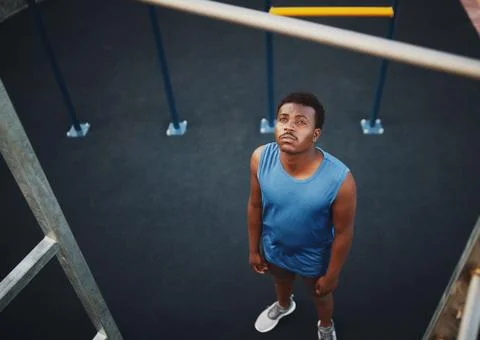 High angle view of a sporty young man preparing to do pull ups on a bar at the Stock Photos