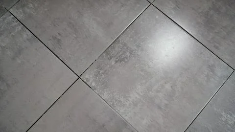 High angle view of square grey floor tiles with industrial concrete texture.. Stock Photos