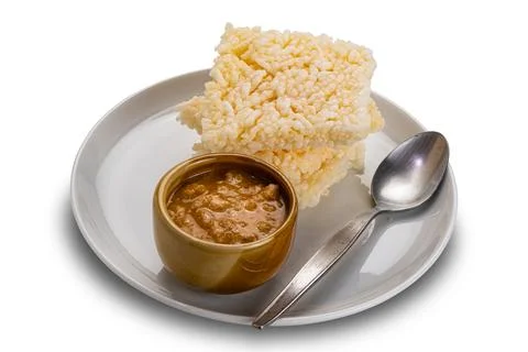 High angle view stack of rice crackers with peanut sauce in brown ceramic cup Stock Photos