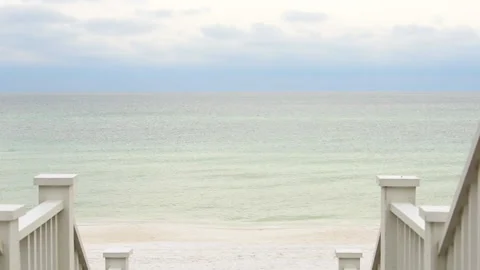 High angle view steps by beach at Gulf of Mexico at Seaside, Florida cloudy day Stock Footage 161829116