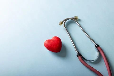 High angle view of stethoscope with red heart shape against blue background, Stock Photos
