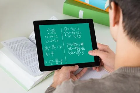 High angle view of student learning mathematical equations on digital tablet  写真素材