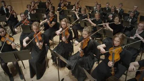 High angle view of student musicians playing violins in orchestra recital 库存照片